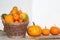 Pumpkins in a wicker basket. Autumn decoration. Outdoors image