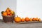 Pumpkins in a wicker basket and a row. Outdoors image in the autumn season