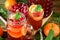 Punch with cranberries and orange decorated with mint and a stick of cinnamon