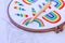Punch needle pinned in afabric with embroidered rainbows