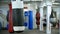 A punching bag hanging in the gym - man boxer walking on the background