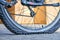 A punctured bicycle wheel on a blurred light sunny background