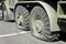 A punctured and flat tire of military equipment of the armored personnel carrier. Military conflict, the shelling of the wheel.