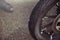 Punctured motorcycle wheel, a nail sticks out of the tire, tire fitting