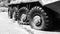 Punctured wheels of an armored personnel carrier after hostilities. Military conflict, war. Black and white photography