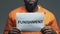 Punishment word on cardboard in hands of Afro-American prisoner, death penalty