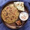 Punjabi thali - Paratha flatbread served with accompaniments