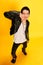 Punk young man guy with piercing grimacing and smiling at camera over yellow background. Concept of fashion, subculture