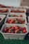 Punnets of fresh strawberries at a local market stall in the Cotswolds, UK