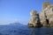 Punta Campanella seen from the sea, in the background the island of Capri and the faraglioni