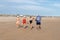 Punta Umbria, Huelva, Spain - May 30, 2020: People walking by the beach wearing protective or medical face masks during the alarm