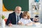 Pupil child lesson. School senior teacher. Education concept. Old grandfather teacher with schoolboy in classroom.