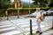 Pupil crossing crosswalk and going to school outdoors in city