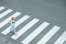 Pupil crossing crosswalk and going to school outdoors in city