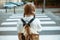 Pupil crossing crosswalk and going to school outdoors in city