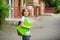 Pupil of elementary school stand in a half-turn to the camera and joyfully smiles