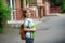 The pupil of elementary school stand on a schoolyard and smiles.