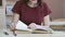 Pupil girl sitting at desk reading school tutorial