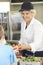 Pupil In School Cafeteria Being Served Lunch By Dinner Lady