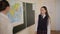 Pupil in school uniform standing near a world map during a geography lesson