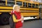 Pupil with schoolbag and bottle of water with yellow school bus on background