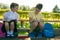 Pupils, a boy and a girl, doing tests of the school program, in the park outdoors, holding pencils