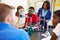 Pupils Carrying Out Experiment In Science Class