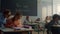 Pupils learning in classroom. Female and male students sitting at desks