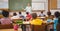 Pupils listening to their teacher at chalkboard