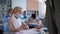 Pupils in medical masks doing schoolwork sitting at desk in the classroom, children back at school after covid-19