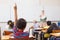 Pupils raising hand in classroom