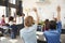 Pupils raising hands in a high school science lesson