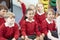 Pupils Sitting On Mat Listening To Teacher