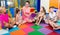 Pupils sitting with teacher and listening to book