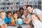 Pupils and teacher looking at globe in library