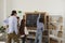 Pupils under the supervision of a teacher with chalk draw different pictures on the school board.