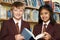 Pupils Wearing School Uniform Reading Book In Library