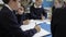 Pupils Working At Table With Teacher Helping Them