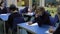 Pupils Working At Table With Teacher Helping Them