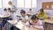 Pupils write in notebooks while sitting at desks in a school class