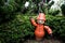 A puppet made of flower pots in a garden.