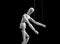 Puppet on strings. Slavery, violence, negative influence, addiction concept. Marionette in human hand. Black and white.