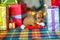 Puppy dachshunds sitting near gifts and playing with Santa`s cap, bright festive garlands in the background
