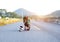 Puppy dog and young women running exercise on the street park in the morning. Young woman teaching her puppy dog obedience gesturi