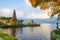 Pura Ulun Danu Bratan temple. Balinese landmark. Water reflection. Foreground with tree branches. Bratan lake, Bedugul, Bali,