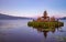 Pura Ulun Danu Bratan temple. Balinese landmark. Water reflection. Foreground with tree branches. Bratan lake, Bedugul, Bali,