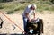 Purbeck, Dorset, UK - Jun 02 2018: Sea angler checking his bait or tackle while on a sandy beach in the sunshine