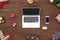 Purchasing Presents Online for New Year. Laptop smartphone and gifts isolated on wooden surface top view close-up