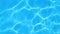 Pure blue water in pool with light reflections. Slow motion. tranquil water in a pool.