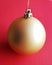 Pure and clean Christmas ball over festive redish background. Merry Xmas decoration.